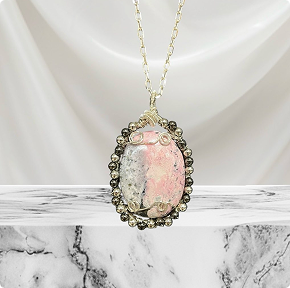 Rhodonite Palm Stone wrapped in Silver Plated Silver accented with Metallic Beads